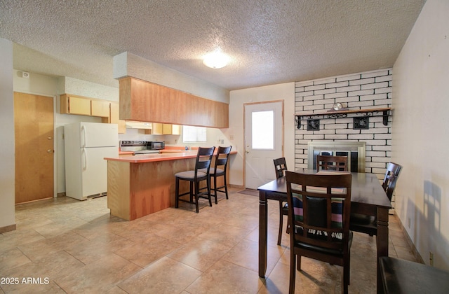 dining space featuring baseboards and a textured ceiling