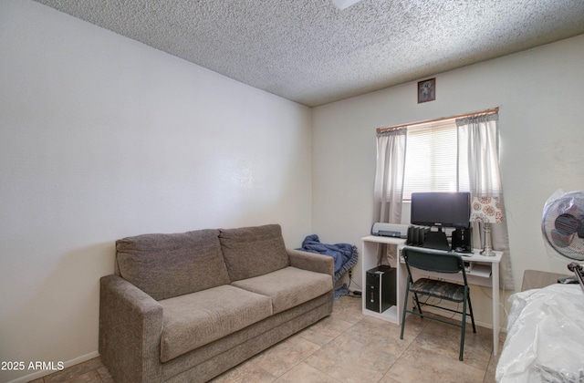 living room featuring a textured ceiling and baseboards