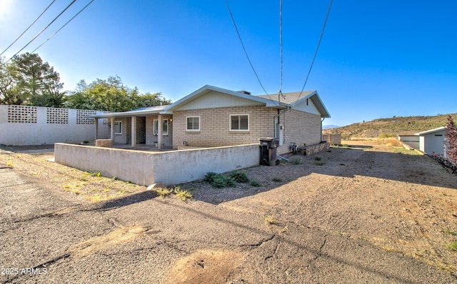 back of property featuring fence and driveway