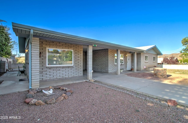 ranch-style home featuring brick siding