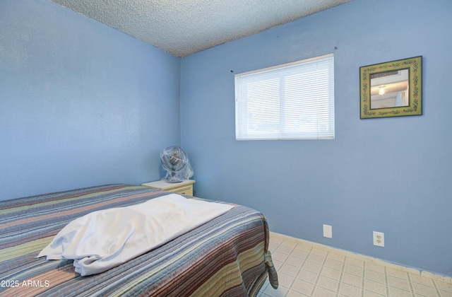 tiled bedroom featuring a textured ceiling