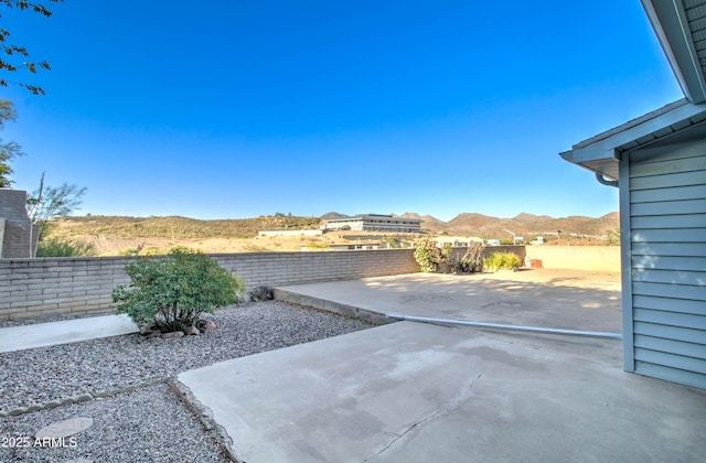view of patio / terrace featuring a mountain view and a fenced backyard
