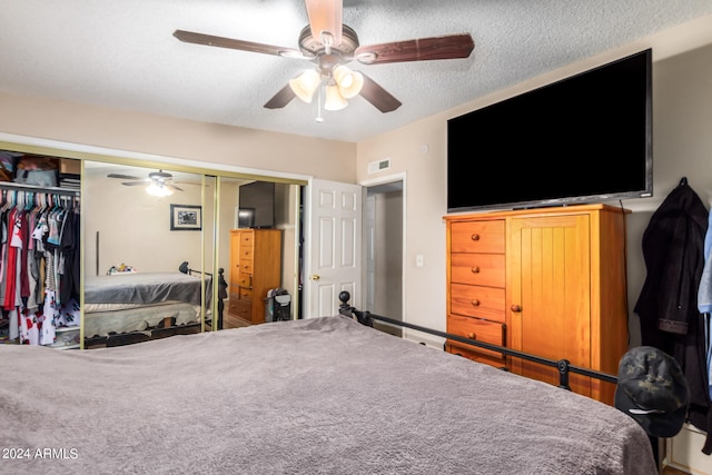 bedroom featuring a ceiling fan, a closet, visible vents, and a textured ceiling