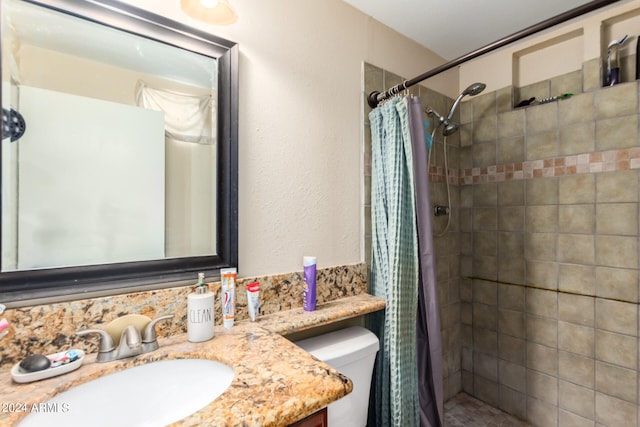 full bath with toilet, a shower stall, and vanity