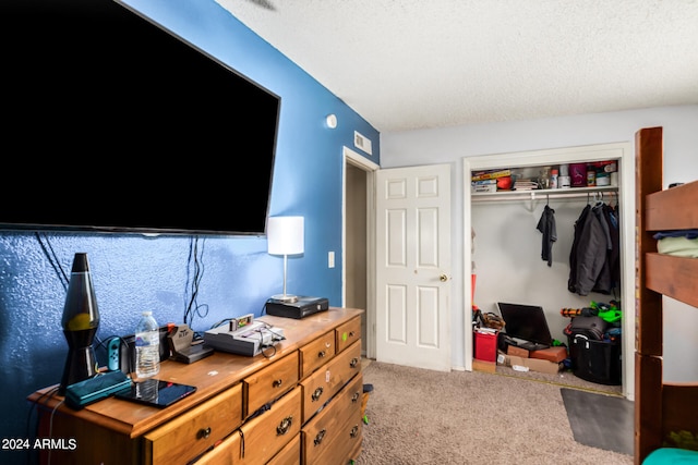 bedroom with light carpet, a closet, and a textured ceiling