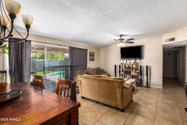 living room featuring ceiling fan, a textured ceiling, and light tile patterned flooring