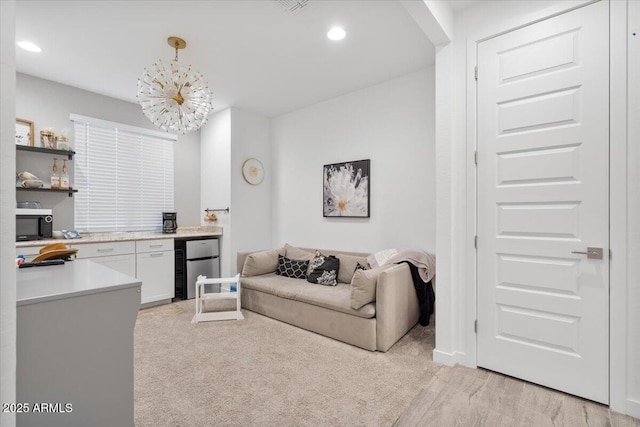 living room with an inviting chandelier and recessed lighting