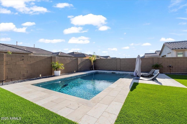 view of swimming pool featuring a fenced backyard, a patio area, a fenced in pool, and a lawn