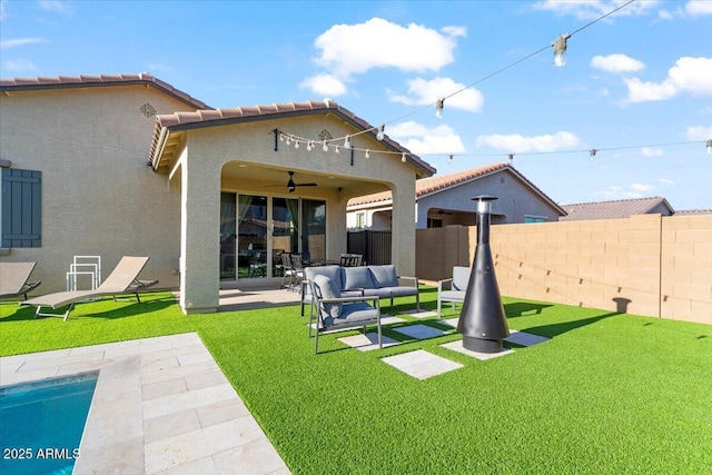back of house with an outdoor living space, a patio area, a ceiling fan, a tiled roof, and a fenced backyard