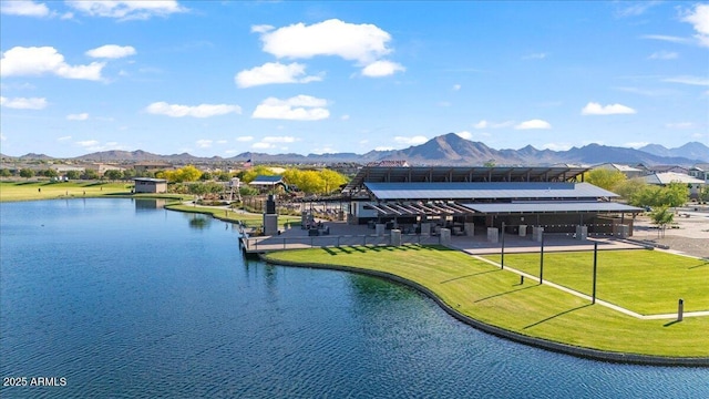 view of community with a water and mountain view and a yard