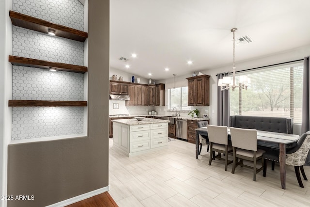 42711 N 45th Dr, Phoenix, AZ 85087 - kitchen with visible vents, pendant lighting, stainless steel dishwasher, an inviting chandelier, and under cabinet range hood