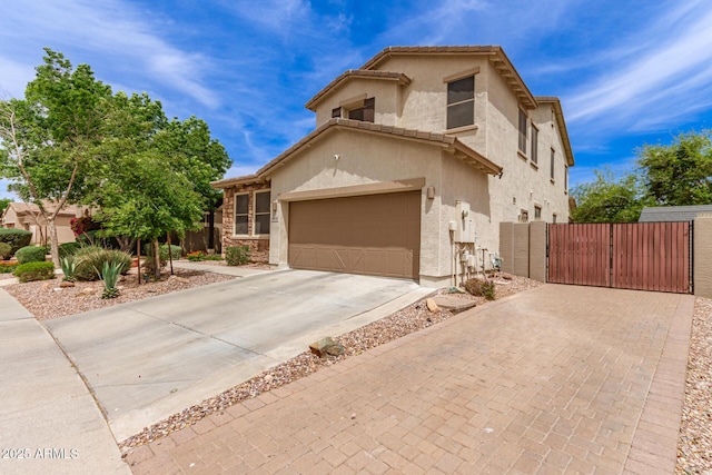 42711 N 45th Dr, Phoenix, AZ 85087 - view of front of house with a garage, fence, stucco siding, a gate, and concrete driveway