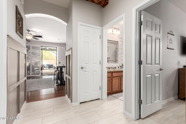 42711 N 45th Dr, Phoenix, AZ 85087 - hall with a sink, baseboards, and arched walkways