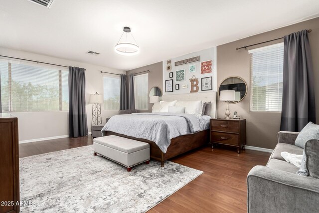 42711 N 45th Dr, Phoenix, AZ 85087 - bedroom featuring baseboards, multiple windows, wood finished floors, and visible vents