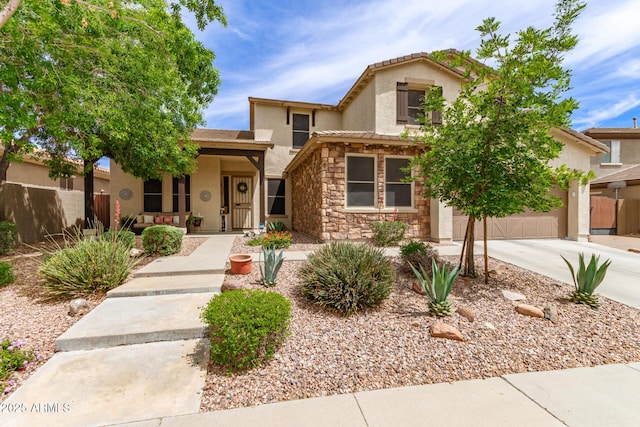 42711 N 45th Dr, Phoenix, AZ 85087 - view of front of house with fence, stone siding, a garage, stucco siding, and driveway