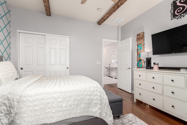 42711 N 45th Dr, Phoenix, AZ 85087 - bedroom with dark wood-style flooring, beamed ceiling, a ceiling fan, and a closet