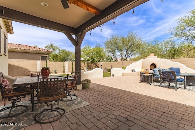 42711 N 45th Dr, Phoenix, AZ 85087 - view of patio / terrace featuring outdoor dining area, a fenced backyard, ceiling fan, and exterior fireplace