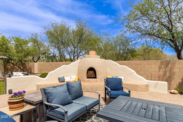 42711 N 45th Dr, Phoenix, AZ 85087 - view of patio with a fenced backyard and an outdoor living space with a fireplace