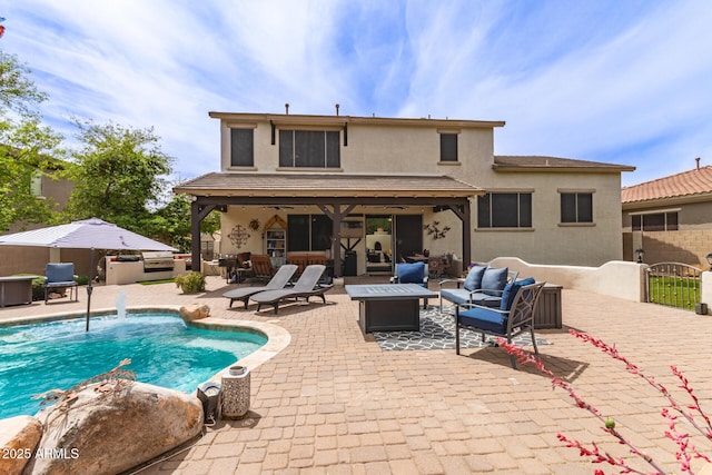 42711 N 45th Dr, Phoenix, AZ 85087 - back of property with stucco siding, a patio, a fenced in pool, and an outdoor living space with a fire pit