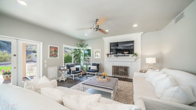 living room featuring dark wood-style floors, recessed lighting, visible vents, and a fireplace