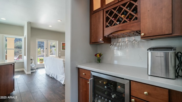 bar featuring wine cooler, recessed lighting, baseboards, french doors, and a dry bar