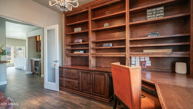 home office with beverage cooler, baseboards, dark wood-type flooring, french doors, and a chandelier