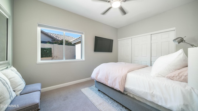 bedroom with ceiling fan, baseboards, a closet, and light colored carpet