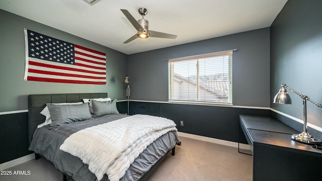 bedroom with ceiling fan, carpet flooring, and baseboards