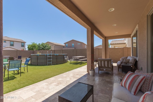 19771 W Woodlands Ave, Buckeye, AZ 85326 - fenced backyard with an outdoor hangout area and a patio area