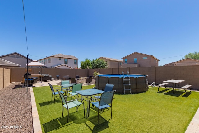 19771 W Woodlands Ave, Buckeye, AZ 85326 - fenced backyard featuring a patio area and outdoor dining area