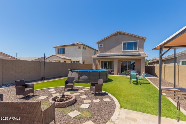 19771 W Woodlands Ave, Buckeye, AZ 85326 - back of house featuring stucco siding, a fenced backyard, and a patio area