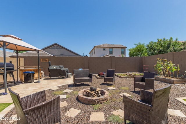 19771 W Woodlands Ave, Buckeye, AZ 85326 - view of patio featuring a vegetable garden, an outdoor fire pit, and grilling area