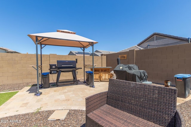 19771 W Woodlands Ave, Buckeye, AZ 85326 - fenced backyard with a gazebo, a patio, and grilling area