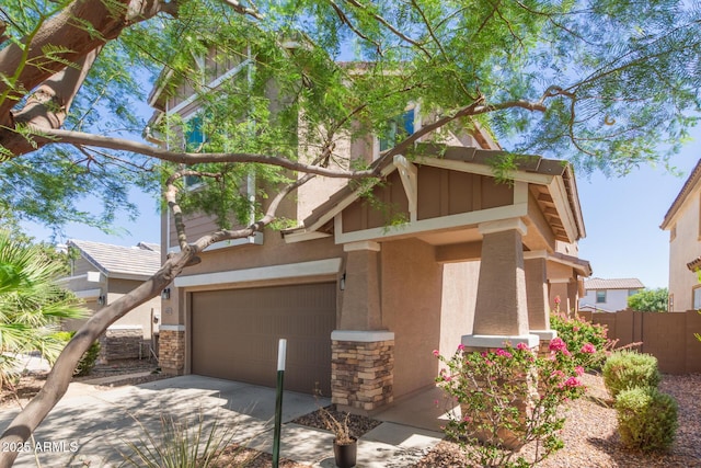 19771 W Woodlands Ave, Buckeye, AZ 85326 - view of front of property with an attached garage, stone siding, stucco siding, and driveway