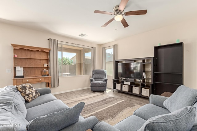 19771 W Woodlands Ave, Buckeye, AZ 85326 - living area with wood finished floors and ceiling fan