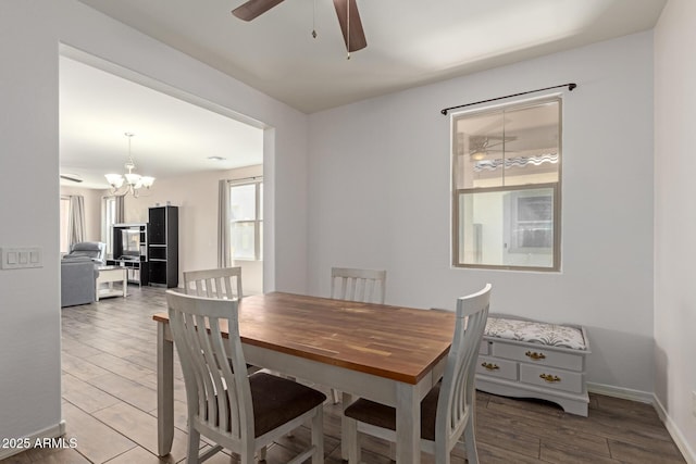 19771 W Woodlands Ave, Buckeye, AZ 85326 - dining area with ceiling fan, a chandelier, and wood finished floors