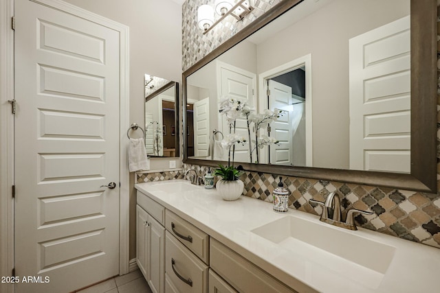 full bath featuring double vanity, decorative backsplash, and a sink