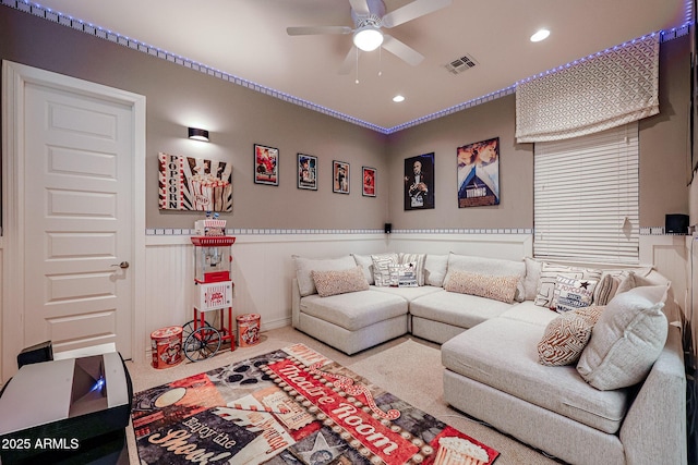 carpeted living room featuring visible vents, a wainscoted wall, a ceiling fan, and recessed lighting