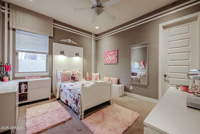bedroom with a ceiling fan, carpet floors, and baseboards