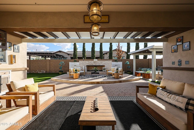 view of patio featuring fence, a pergola, and an outdoor living space with a fireplace