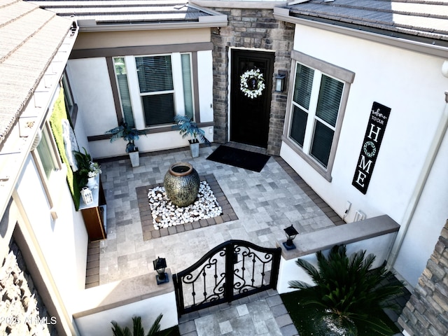 entrance to property with stucco siding and stone siding