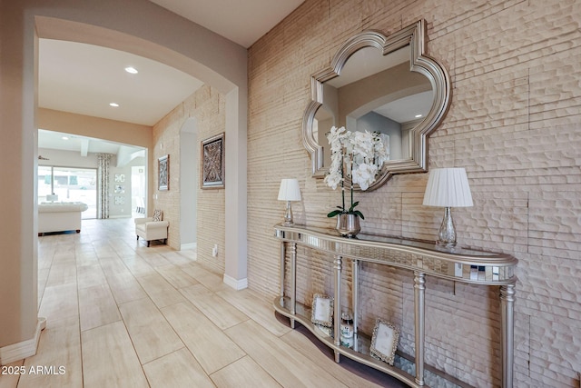 hall with recessed lighting, arched walkways, wood finished floors, and baseboards