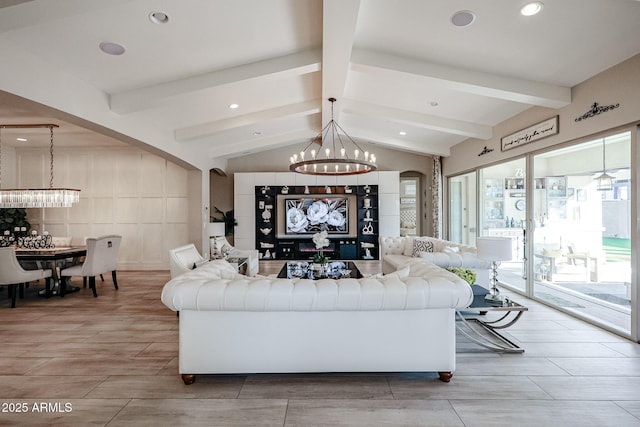 living room featuring lofted ceiling with beams, wood tiled floor, and a chandelier