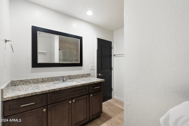 bathroom with vanity and hardwood / wood-style floors