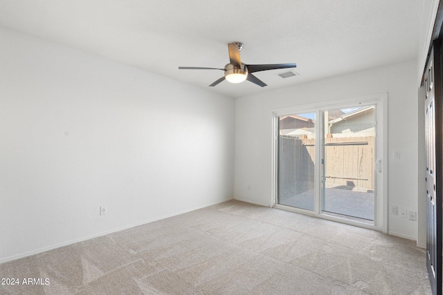 spare room with light colored carpet and ceiling fan