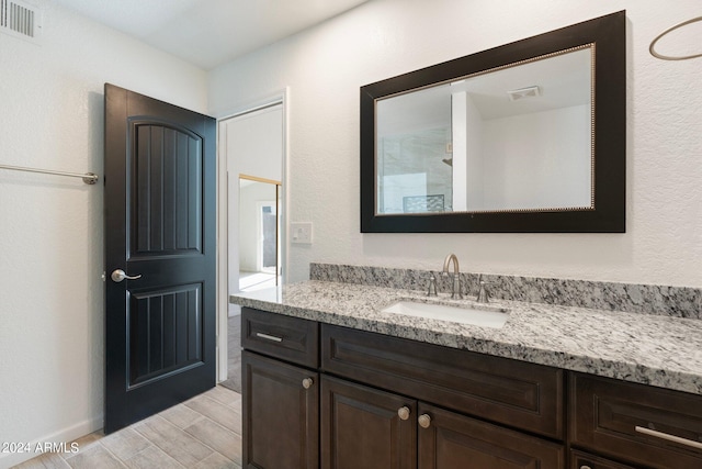 bathroom with vanity and hardwood / wood-style flooring