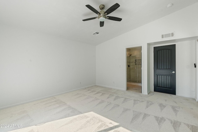 unfurnished bedroom with ensuite bath, lofted ceiling, light colored carpet, and ceiling fan