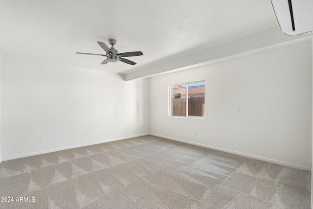 empty room featuring ceiling fan and light colored carpet