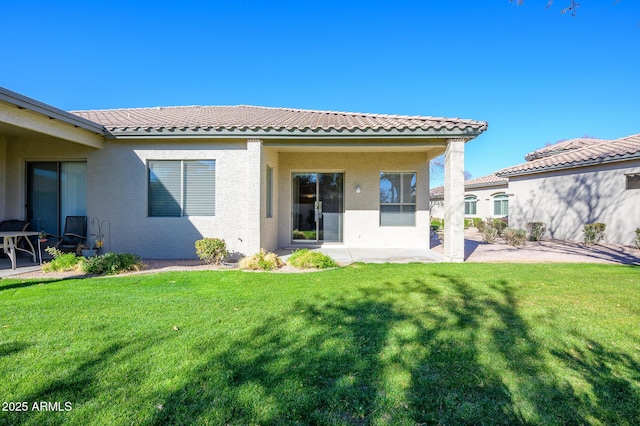 back of property featuring a patio and a yard