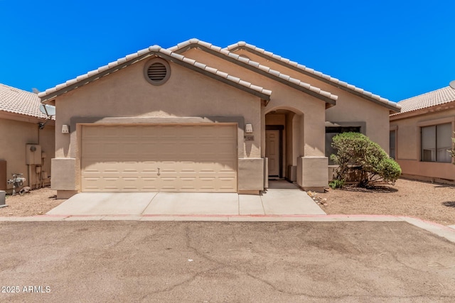 125 N 22nd Pl Unit 128, Mesa, AZ 85213 - view of front of property with an attached garage, stucco siding, a tiled roof, and driveway